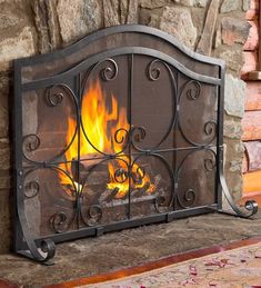 an iron fireplace screen with flames in it