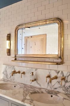 a bathroom vanity with two sinks and a large mirror