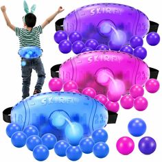 a young boy standing on top of an inflatable object surrounded by other balloons