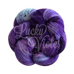 skeins of purple and blue yarn with the words lucky wool written on it