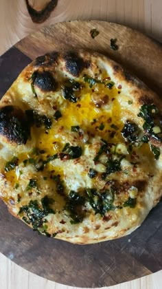 a pizza sitting on top of a wooden cutting board