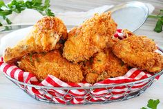 fried chicken in a basket with parsley on the side, ready to be eaten