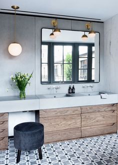 a bathroom with two sinks and a large mirror