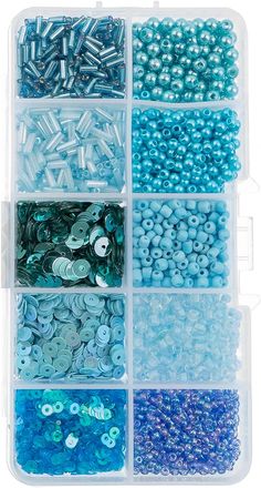 a plastic container filled with lots of different types of buttons and beads on top of each other