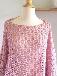 a pink crocheted sweater on a mannequin