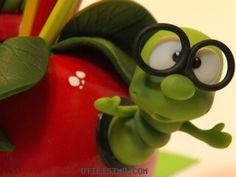 a close up of a cartoon character on an apple