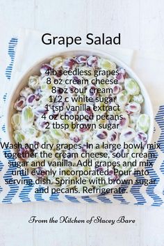 a bowl filled with grapes and cream on top of a blue and white table cloth