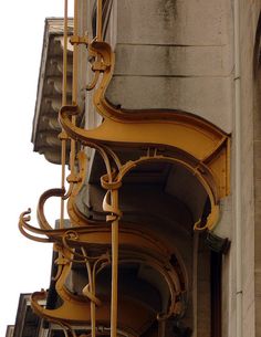 an old building with ornate iron work on the side