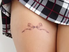 Delicate tattoo of a transparent black bow on the front of the thigh Cute Above Knee Tattoos Women, Bunny With Bow Tattoo, Bows Tattoos For Women Thighs, Back Thigh Bow Tattoo, Bow Tattoo On Thigh, Vintage Bow Tattoo, Bow Tattoo Lower Back, Small Inner Thigh Tattoos, Bow Leg Tattoo