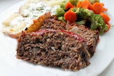 a white plate topped with meat and veggies next to mashed potatoes, broccoli and carrots