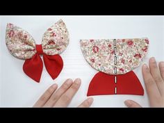 two bows are being made from fabric and one is red with white flowers on it