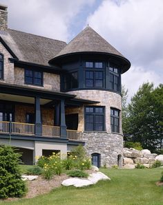 a large house sitting on top of a lush green field