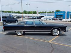 a black car parked in a parking lot