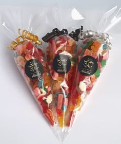 three bags filled with different types of candy