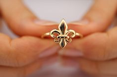 Fleur De Lis French lily flower. 14K Pure Gold European Royal Symbol Ring This solid gold dainty ring is made entirely from 14k solid gold. * Jewelry is packaged and shipped in a delicate jewelry gift box. * If you are purchasing it as a gift, please feel free to add a personal note. Anniversary, Gift For Wife, Christmas Gift Gold Kt: 14K solid gold * Available Gold Color: * Guaranteed Authentic 14k Gold, NOT Plated Or Filled * Stamp: 14K Lily Ring, Royal Rings, Mom Ring, Solid Gold Band, Gold Rings Fashion, Gold Statement Ring, Jewelry Lookbook, Solid Gold Rings, Fancy Jewelry