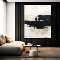 a living room with black and white artwork on the wall, coffee table and couch