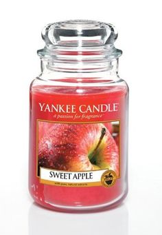 yankee candle jar filled with an apple and cinnamon flavored in pink, yellow or red