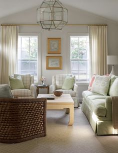 a living room filled with furniture and windows