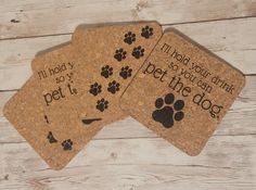 three coasters with dogs footprints on them