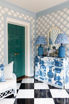 a blue and white checkered floor in a room with two lamps on the table