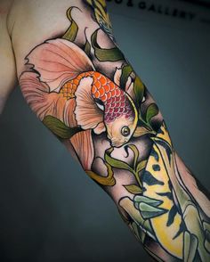 a man with a tattoo on his arm has a goldfish in it's body