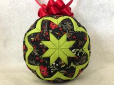 an ornament with a red bow on it