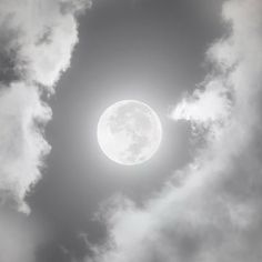 the sun is shining brightly through clouds in this black and white photo, with only one cloud visible