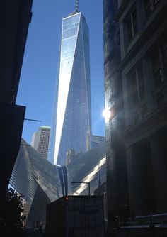 the sun shines brightly in front of one world trade center