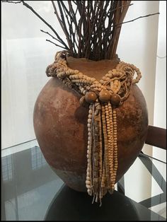 a vase with some branches in it on a table