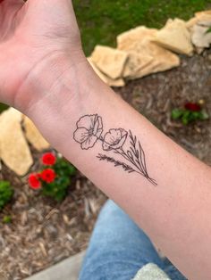 a person with a flower tattoo on their arm