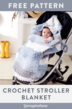 the crochet stroller blanket is shown in blue and white, with a baby wrapped