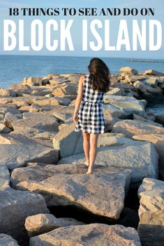 a woman walking on rocks near the ocean