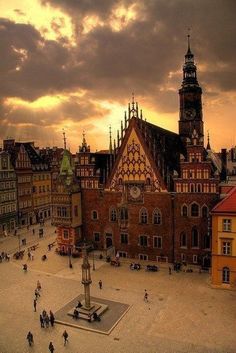 an aerial view of a city square with people walking around and buildings in the background