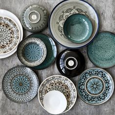 many plates and bowls are arranged on the table