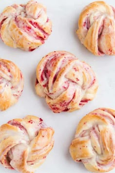 freshly baked croissants with icing on a white surface