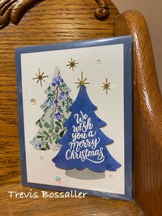 a handmade christmas card on a wooden chair