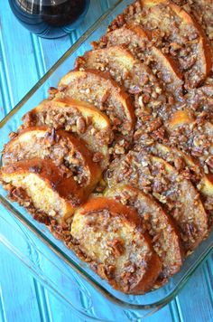 a casserole dish filled with lots of food on top of a blue table