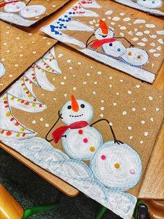 the children's artwork is made with colored pencils and paper mache, including snowmen