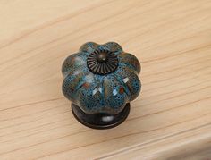 a close up of a knob on a wooden surface