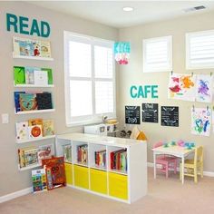 a child's playroom with bookshelves, desks and toys on the wall