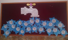 a bulletin board with paper flowers and a water faucet on it's side