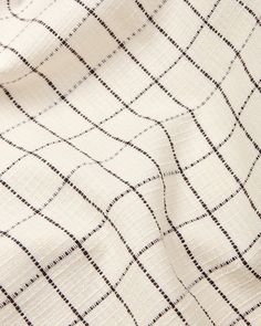 a white and black checkered fabric with small squares on the top, as well as lines