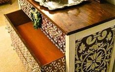 a wooden table with an ornate design on it