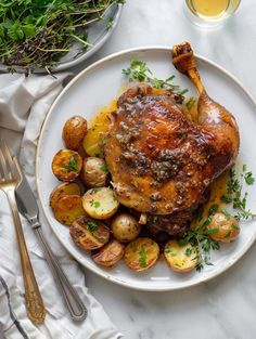 a white plate topped with chicken and potatoes