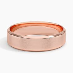 a rose gold wedding ring on a white background