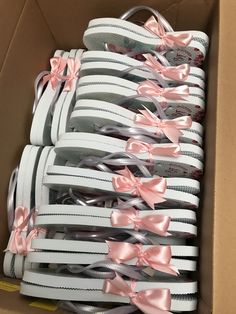 a box filled with lots of white and pink shoes