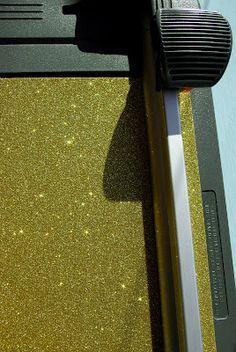 a close up view of the side of a computer with glittery gold paint on it