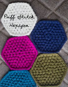 four crocheted hexagons sitting on the ground