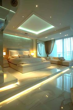 a large bedroom with white furniture and lights on the ceiling is lit by recessed lighting