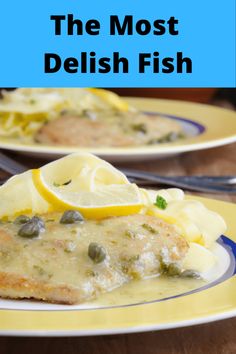 the most delish fish is served on two plates with lemon wedges and capers